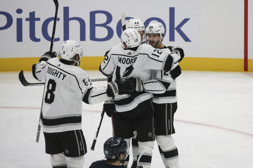 The Kings' Phillip Danault, at right, celebrates with teammates after his second-period goal Saturday night.