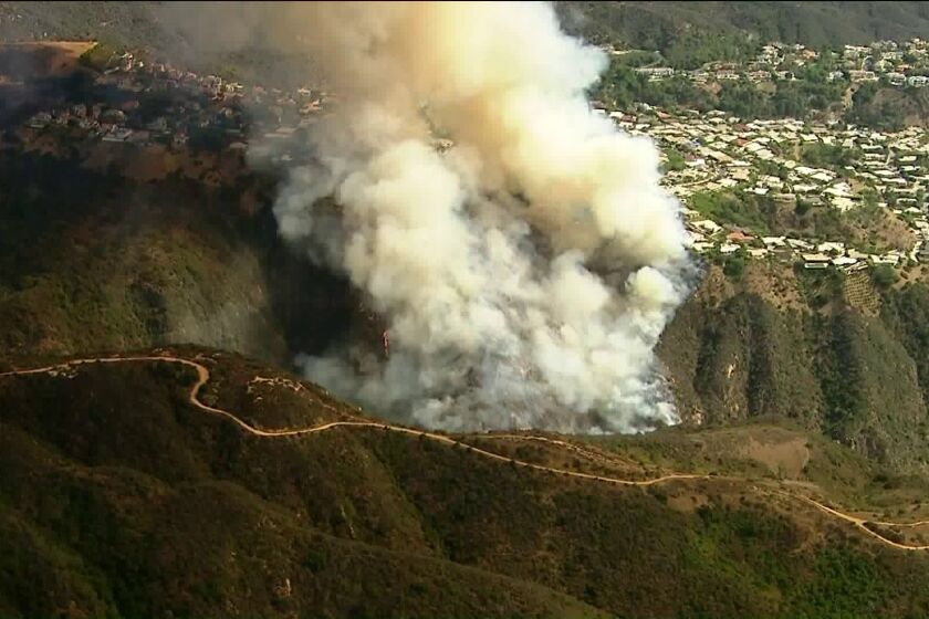 Los Angeles fire crews are responding to a roughly one-acre brush fire burning uphill near the 500 block of North Palisades Drive in Pacific Palisades.