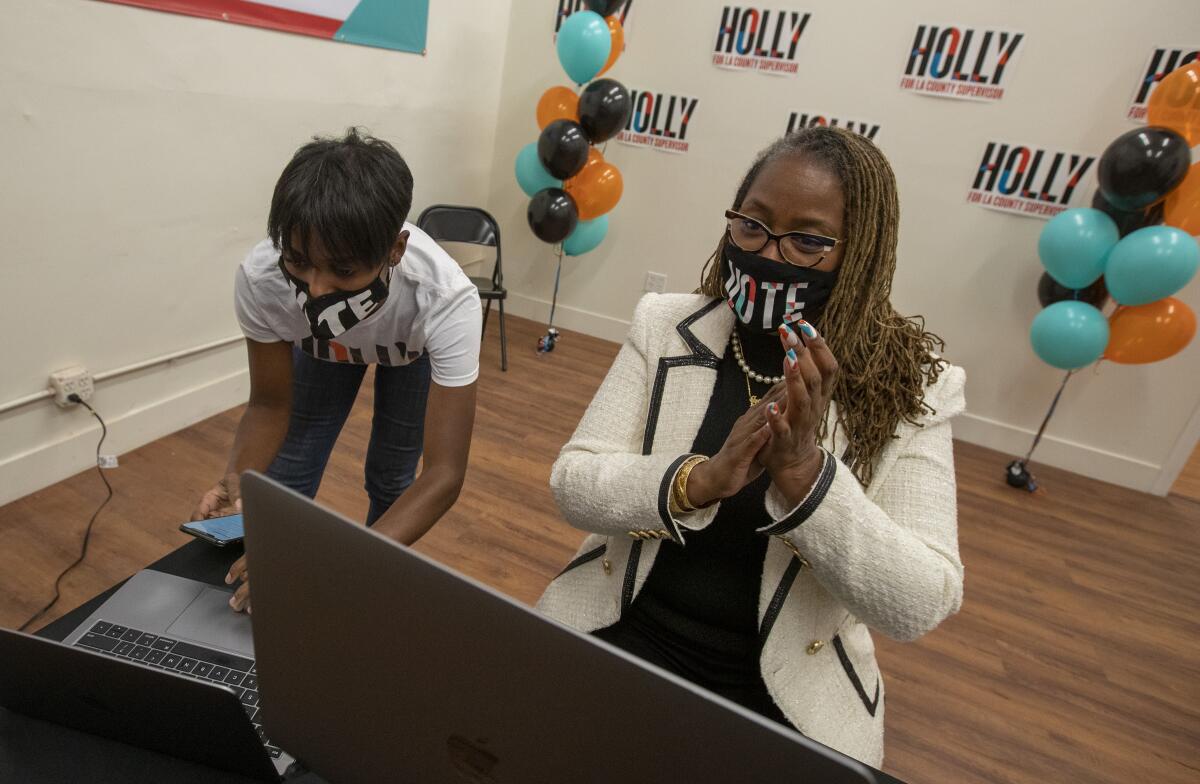 State Sen. Holly Mitchell, right, and campaign manager Lenee Richards watch election results Tuesday night.
