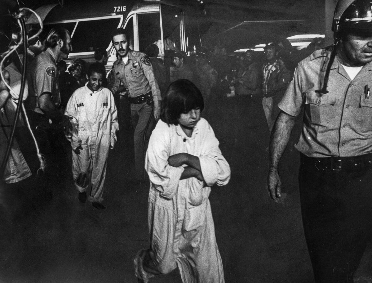 July 17, 1976: Officers escort chidren from Greyhound bus upon their return to Chowchilla at 4 a.m.