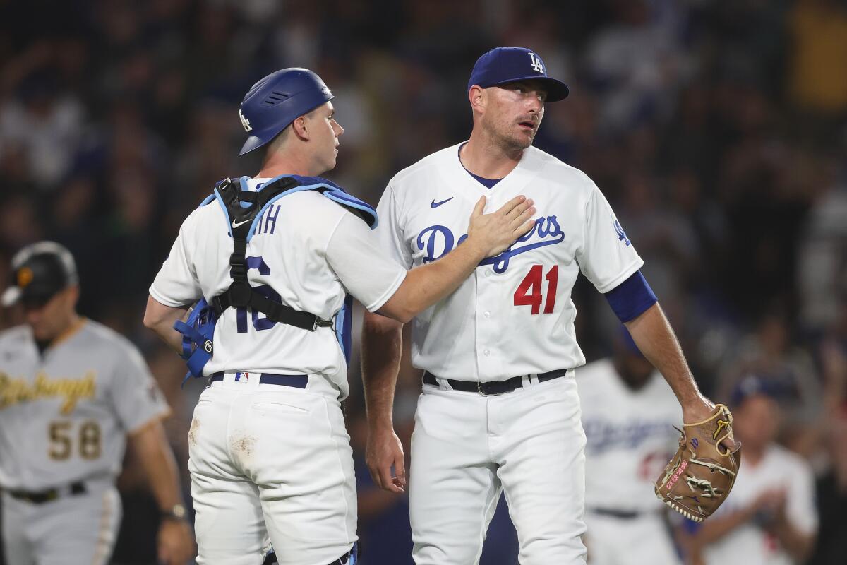 Daniel Hudson, right, and Will Smith celebrate the Dodgers' 6-4 victory against the Pittsburgh Pirates on July 5, 2023.