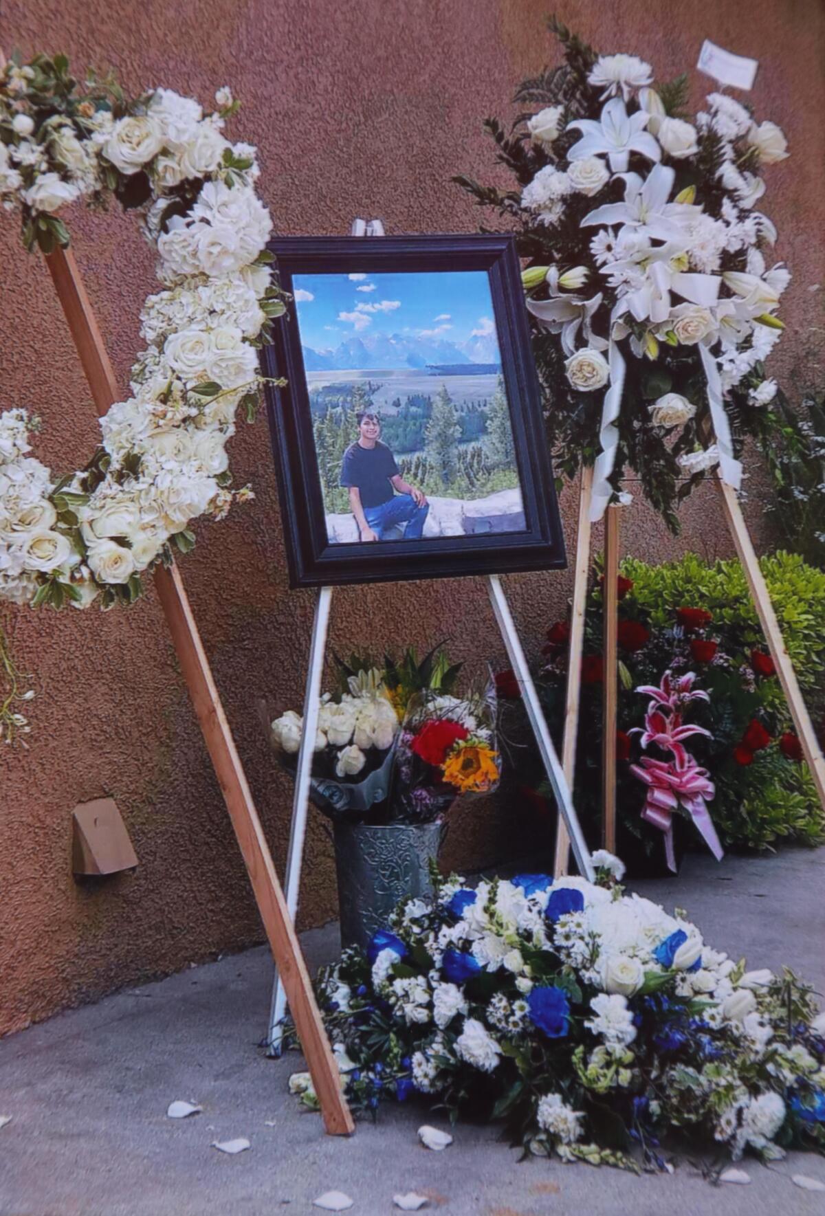 A memorial for Bryan Diaz appears in a photograph in a family album.