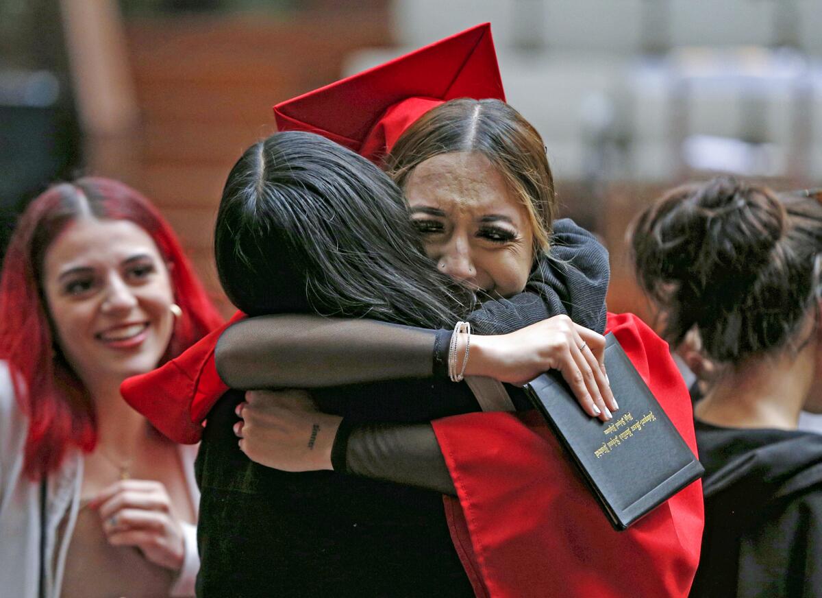 Back Bay/Monte Vista graduate Ruby Villicana gets a big hug from Erma Felix Thursday after the school's commencement.