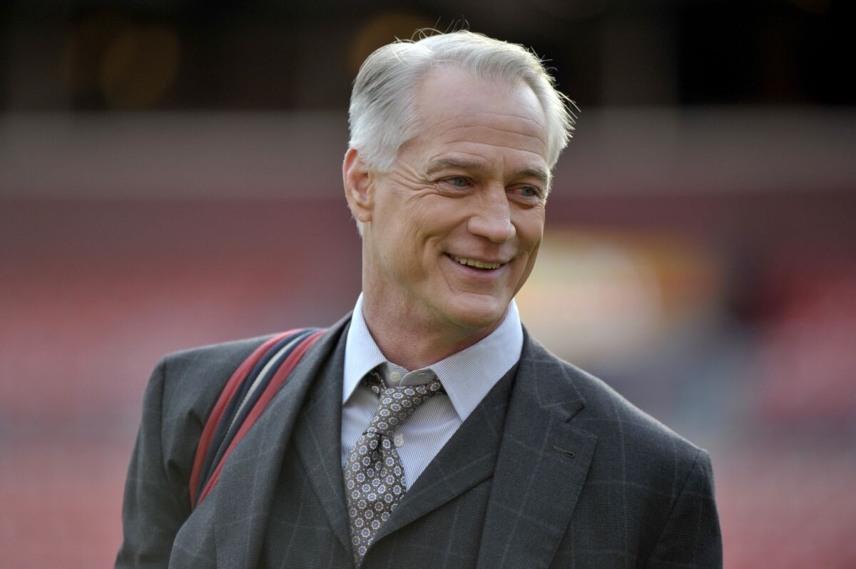 FILE - Former Dallas Cowboys standout and longtime NFL on FOX game analyst Daryl Johnston stands on the field prior to an NFL football game between the Philadelphia Eagles and Washington Redskins, Sunday, Dec. 30, 2018, in Landover, Md. Johnson is Executive Vice President, Football Operations for the USFL, that kicks off Saturday night in Birmingham, Ala.(AP Photo/Mark Tenally, File)