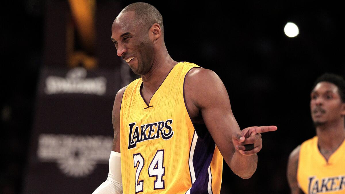 Lakers forward Kobe Bryant (24) chuckles and points to the official after being called for a foul during a game against the Bucks on Tuesday.