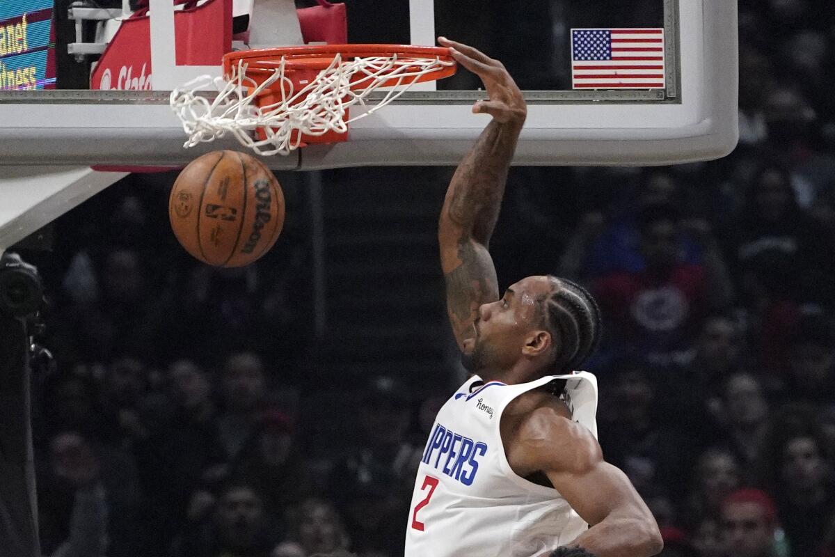 Clippers forward Kawhi Leonard dunks during the first half against the Hawks.