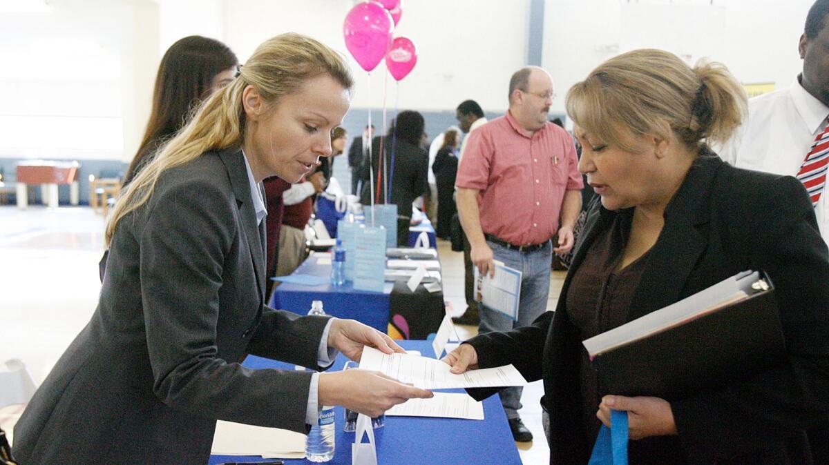 Angie Galgocz-Deak, of IPC, accepts the resume of Leticia Pena during a job fair in 2013 at the McCambridge Park Community Center in Burbank. Glendale Community College will hold its job fair from 10 a.m. to 2 p.m. Thursday. (File photo)