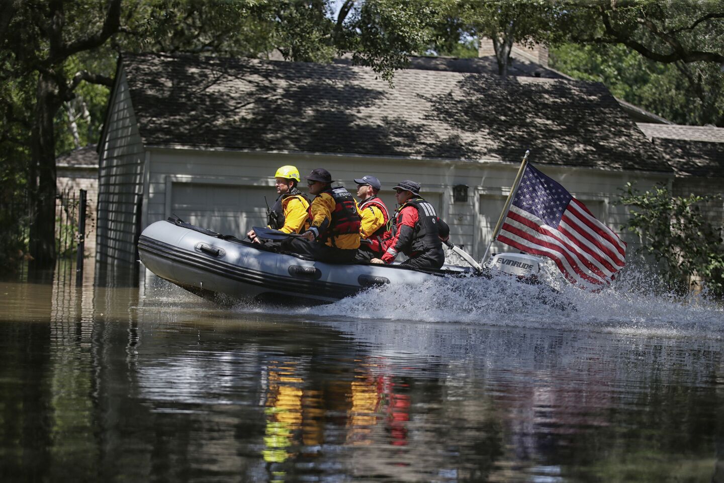 A search-and-rescue crew speeds along Maple Rock Drive in west Houston looking for flood victims.