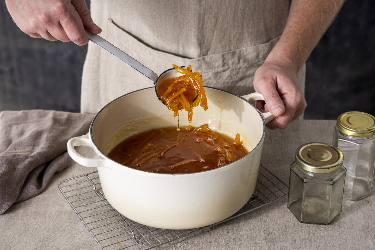 Citrus marmalade being made in a dutch oven.