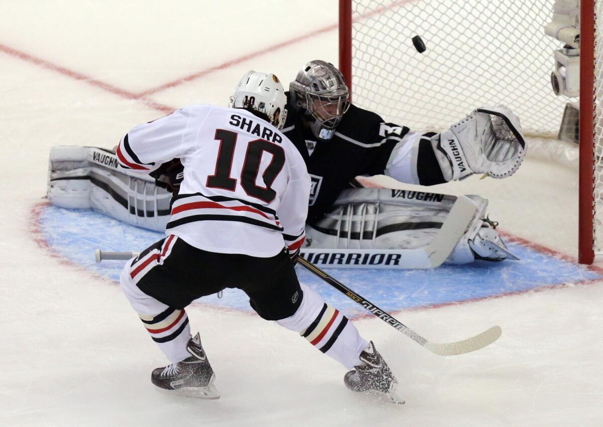 Kings goaltender Jonathan Quick deflects a point-blank shot by Blackhawks left wing Patrick Sharp in the second period Friday in Game 6.