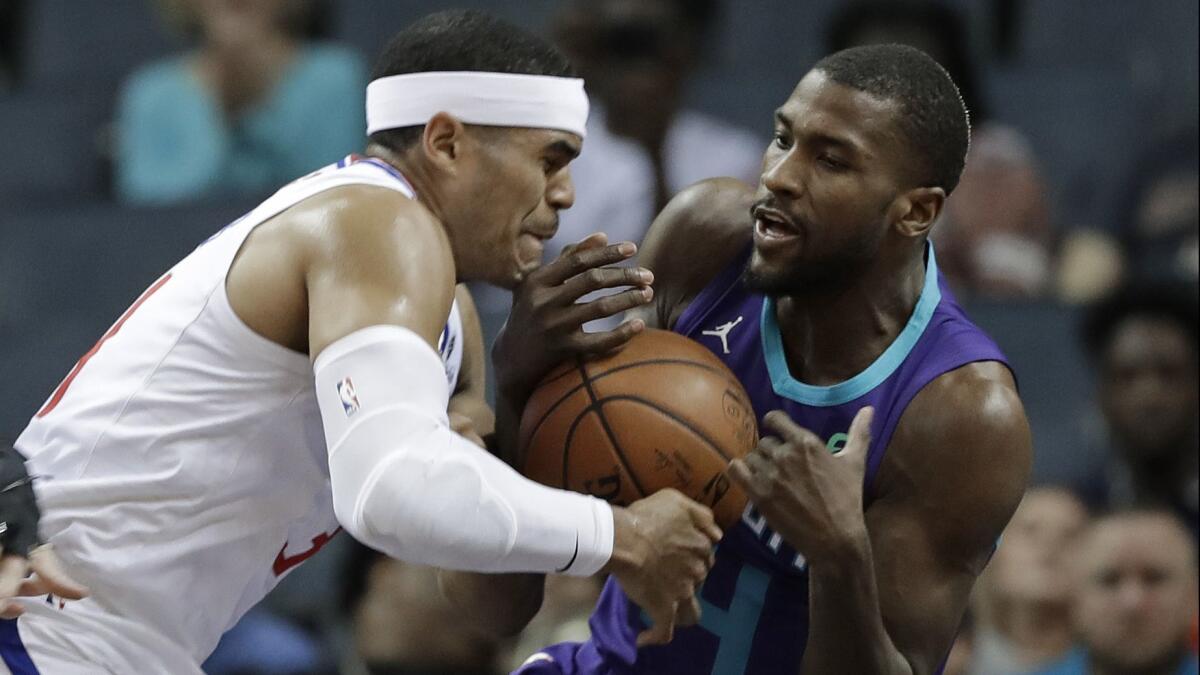 The Charlotte Hornets' Michael Kidd-Gilchrist, right, steals the ball from the Clippers' Tobias Harris, left, on Feb. 5.