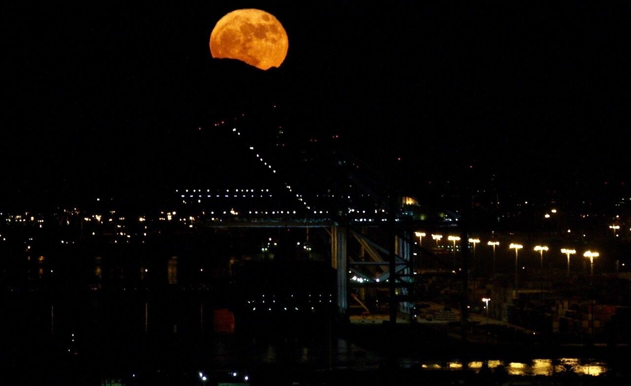 The supermoon beams above the Port of Los Angeles in San Pedro.