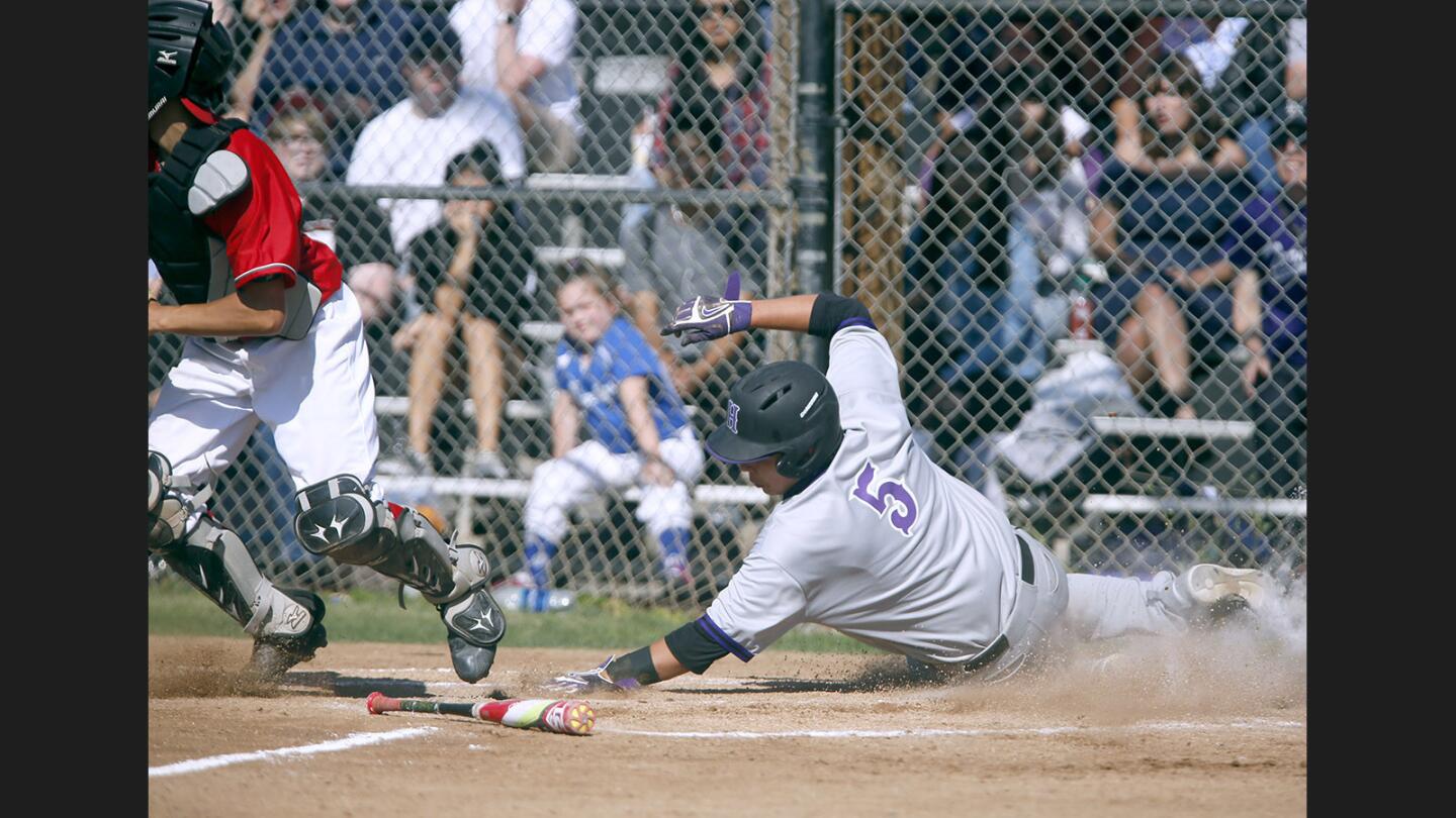 Hoover High School baseball player #5 John Paul Gallegos slides in and scores a run in game vs. Glendale High School at the Dynamiters' home field in Glendale on Friday, May 12, 2017.