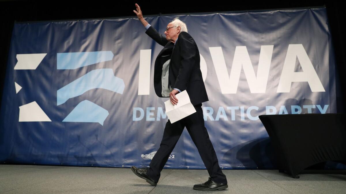 Sen. Bernie Sanders (I-Vt.) walks onstage at the Iowa Democratic Party's Hall of Fame Celebration on Sunday. He joined 18 other presidential candidates wooing voters at the Cedar Rapids event.