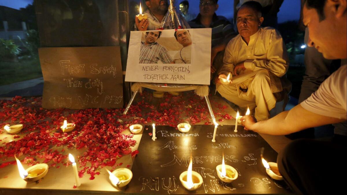 Members of the Pakistani media pay tribute to Afghan journalists killed in Monday's suicide bombing in Kabul.