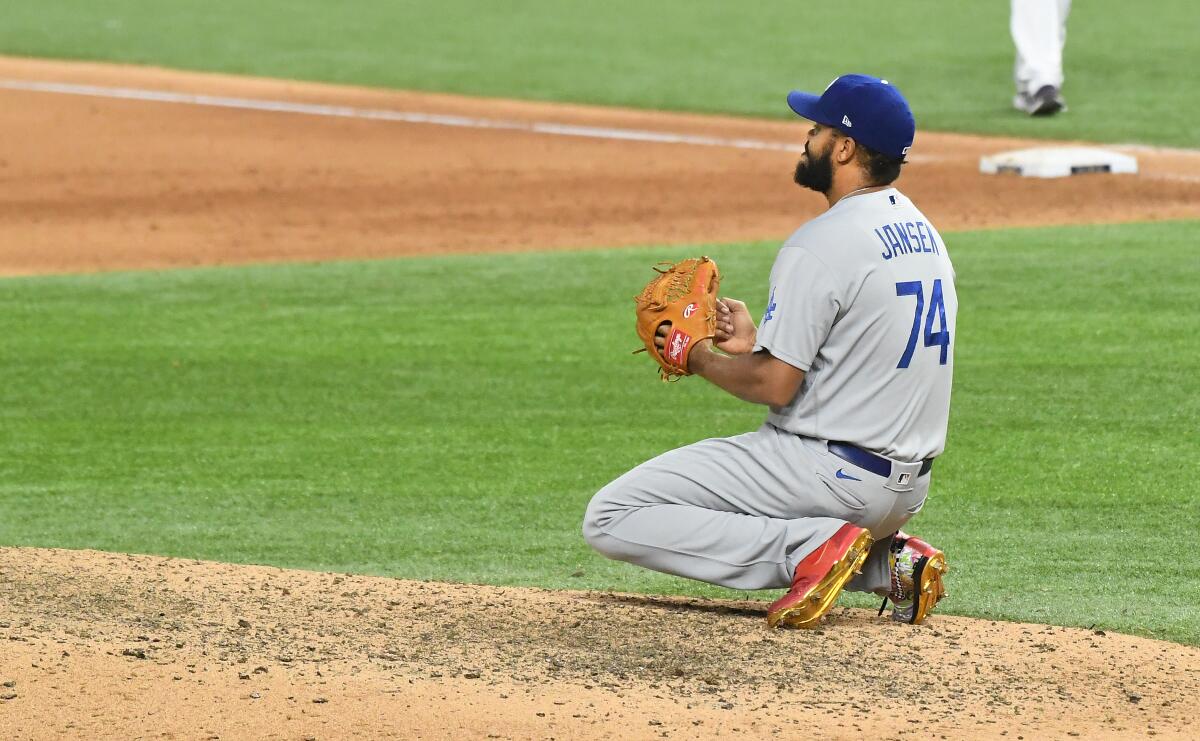 Dodgers' Kenley Jansen drops to his knees after giving up a walk-off single in Game 4 of the World Series.