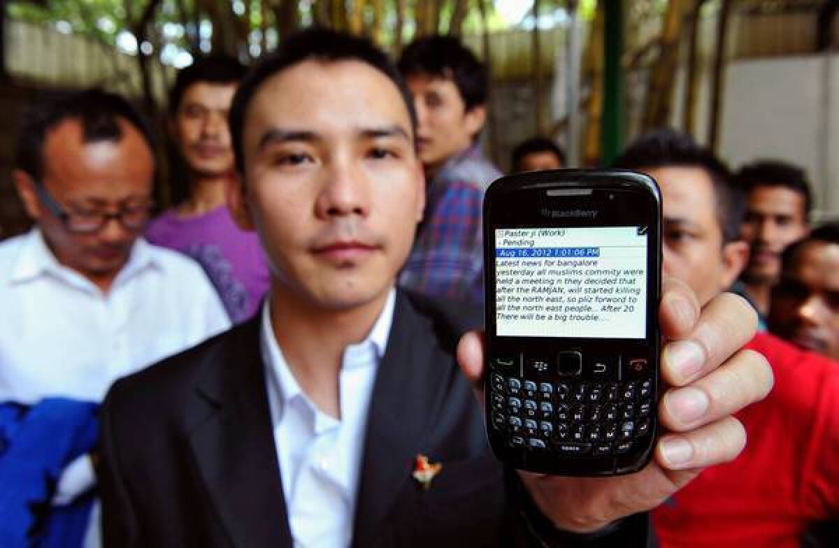 A northeastern Indian displays a text message warning about the safety of his minority community in the city of Bangalore. India imposed limits on text messages in the wake of violence involving people from the northeast.