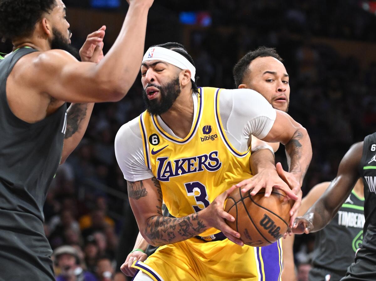 Lakers' Anthony Davis has the ball stolen by Minnesota Timberwolves' Kyle Anderson while driving to the basket.
