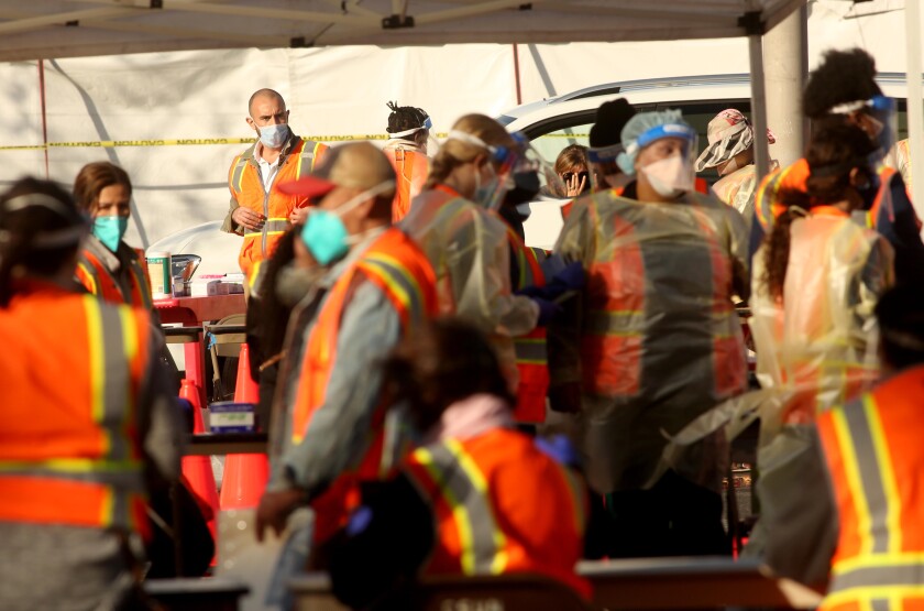 Medical personnel and other workers at the large-scale COVID-19 vaccine site at Cal State Northridge.