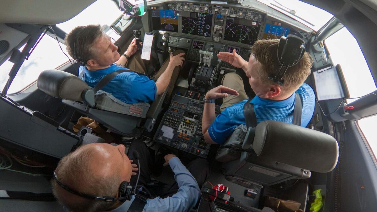 Boeing CEO Dennis Muilenburg, lower left, joins Boeing test pilots for a flight demo of updated software on a 737.