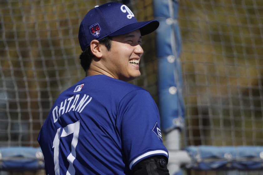 Goodyear, Arizona, Wednesday, February 14, 2024 - Los Angeles Dodgers' Shohei Ohtani heads on the field for a spring training workout at Camelback Ranch. (Robert Gauthier/Los Angeles Times)