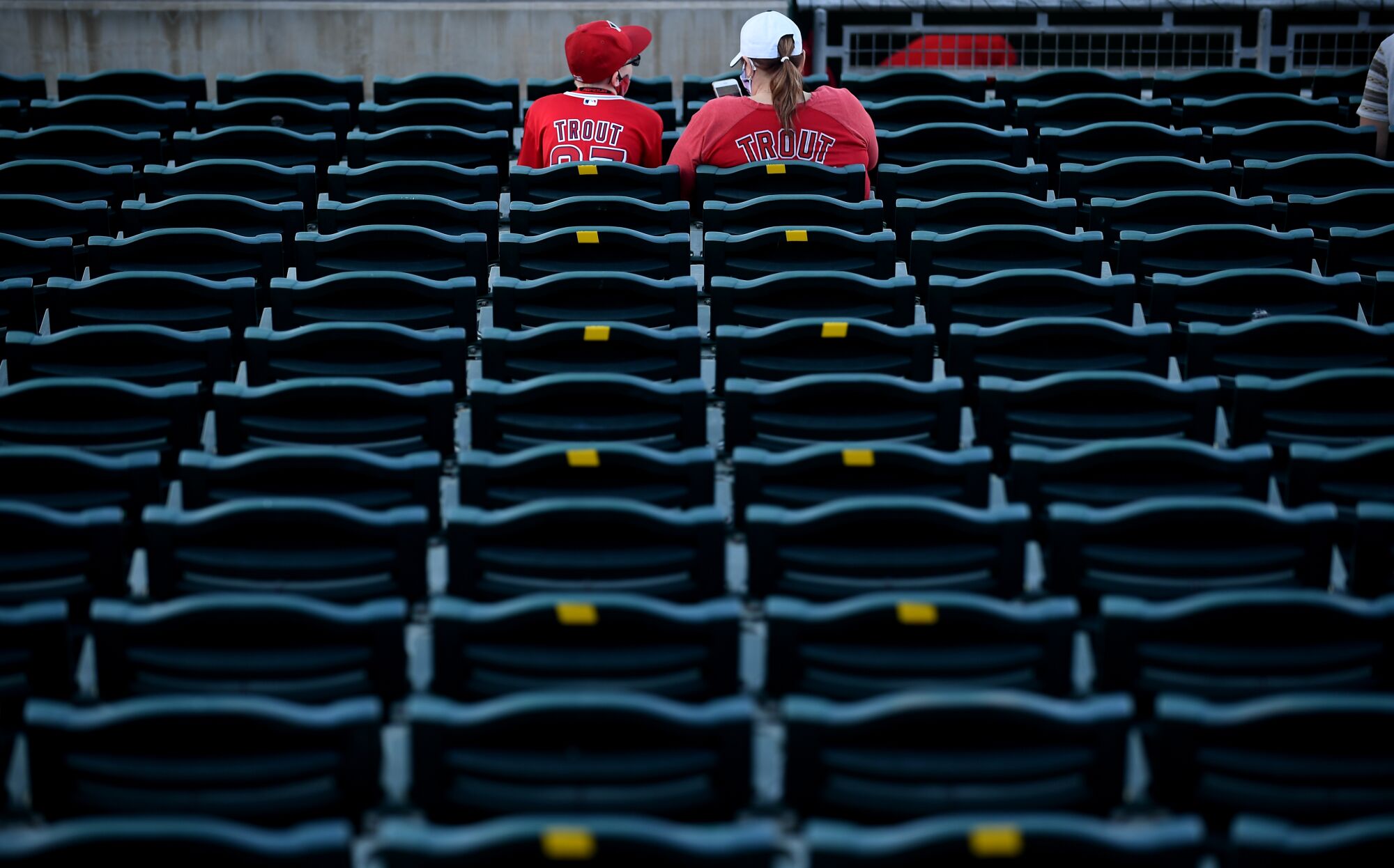 Angels fans watch warmups Tuesday before a game against the Reds at spring training in Goodyear, Ariz.
