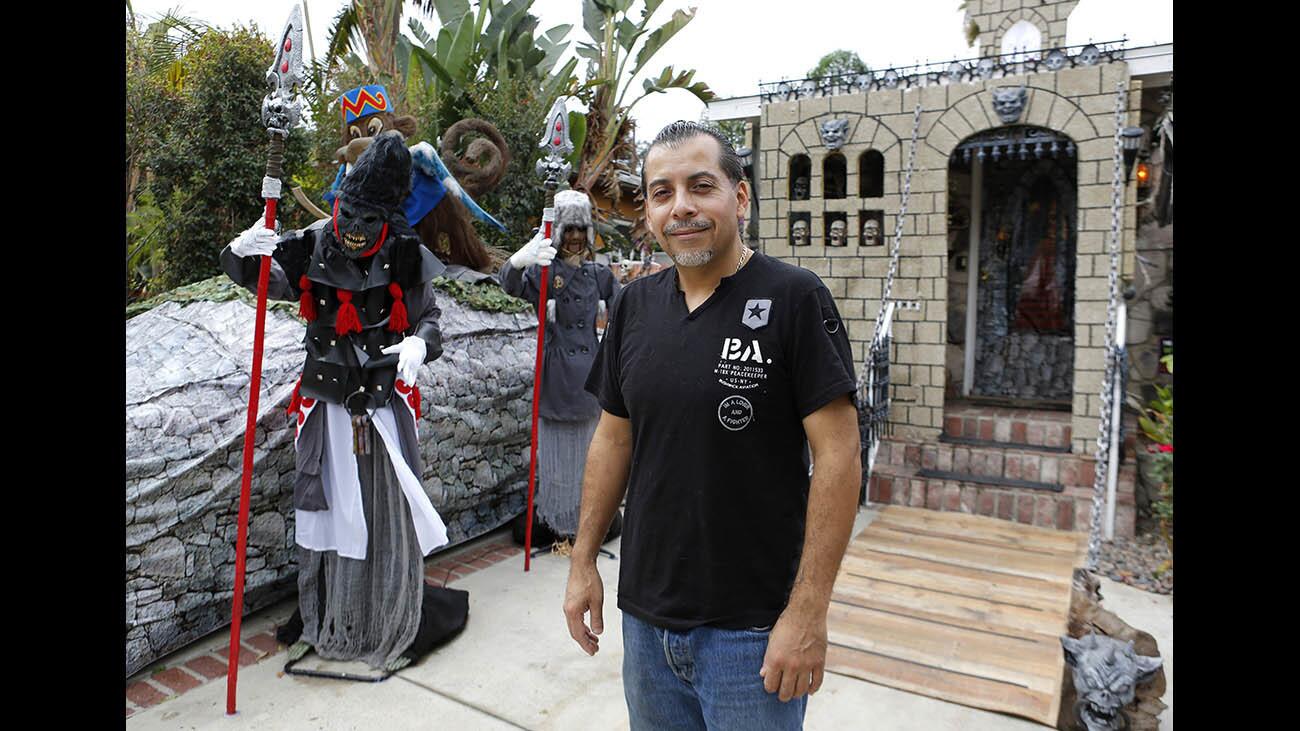 Arnulfo Padilla stands next to part of his Halloween home decorations, which won the Burbank Halloween Decorating Contest for the second time in a row with his theme "Wizard of Oz," at his home at 1505 N. Valley St., in Burbank on Tuesday, Oct. 31, 2017.