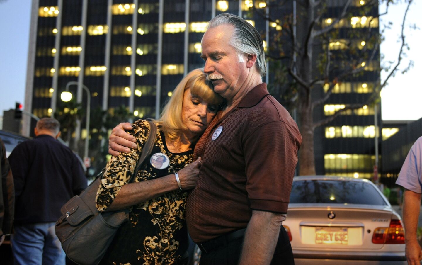 Ron and Kathy Thomas embrace outside the Santa Ana Courthouse Monday after two Fullerton police officers were found not guilty in the murder of their son Kelly.