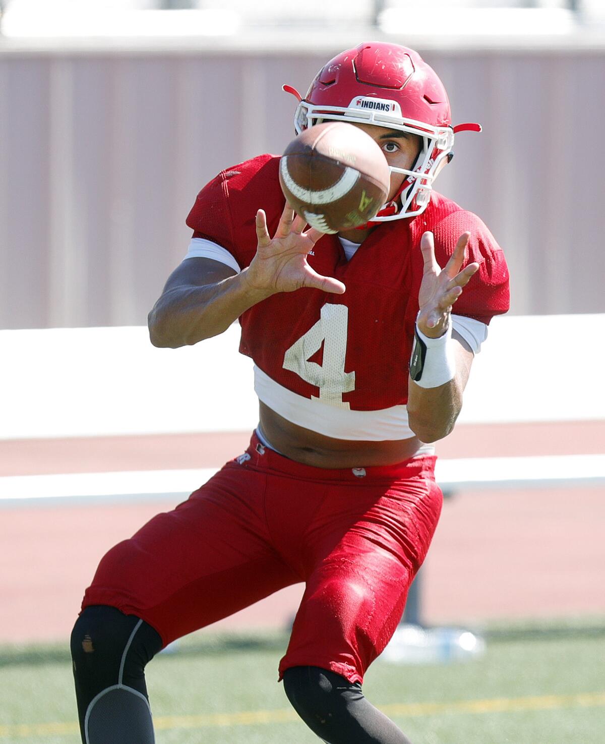 Burroughs' Ellington Simmons brings in a pass during a passing drill at football practice at Burroughs High School in Burbank on Tuesday, August 13, 2019.