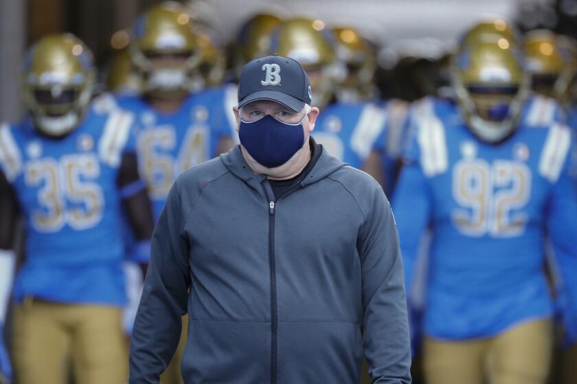 UCLA head coach Chip Kelly lenters the field before an NCAA college football game between UCLA and Stanford Saturday, Dec. 19, 2020, in Pasadena, Calif. (AP Photo/Ringo H.W. Chiu)