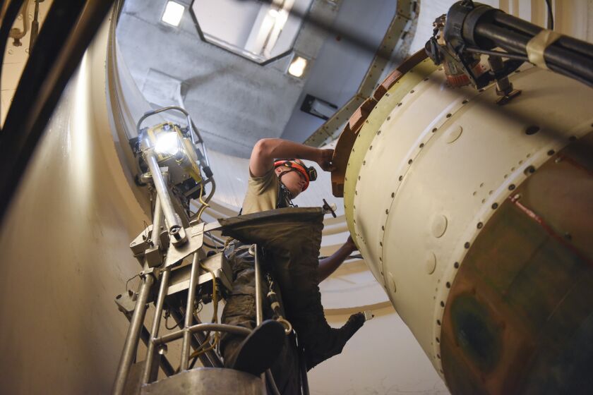 FILE - In this image provided by the U.S. Air Force, Airman 1st Class Jackson Ligon, 341st Missile Maintenance Squadron technician, prepares a spacer on an intercontinental ballistic missile during a Simulated Electronic Launch-Minuteman test Sept. 22, 2020, at a launch facility near Malmstrom Air Force Base in Great Falls, Mont. The U.S. says it is tracking a suspected Chinese surveillance balloon that has been spotted over U.S. airspace for a couple days but the Pentagon decided not to shoot it down due to risks of harm for people on the ground. One of the places the balloon was spotted was Montana, which is home to one of the nation's three nuclear missile silo fields at Malmstrom Air Force Base (Tristan Day/U.S. Air Force via AP)