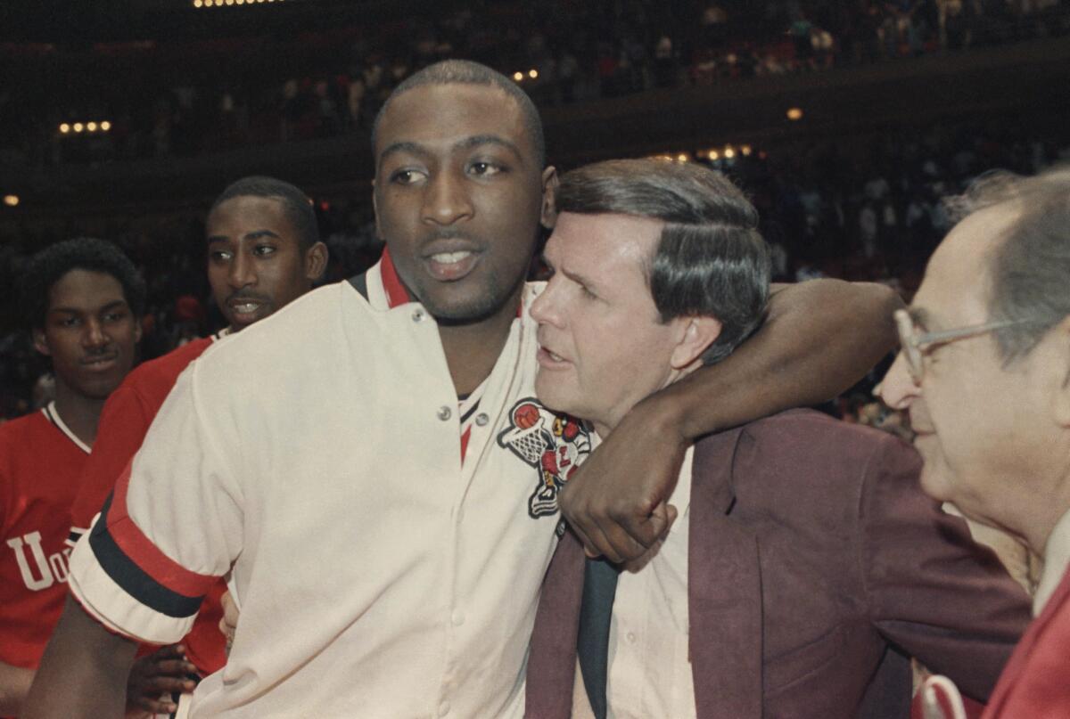 Louisville's Robbie Vallentin hugs coach Denny Crum after beating Auburn 84-76 for the West NCAA championship in Houston.
