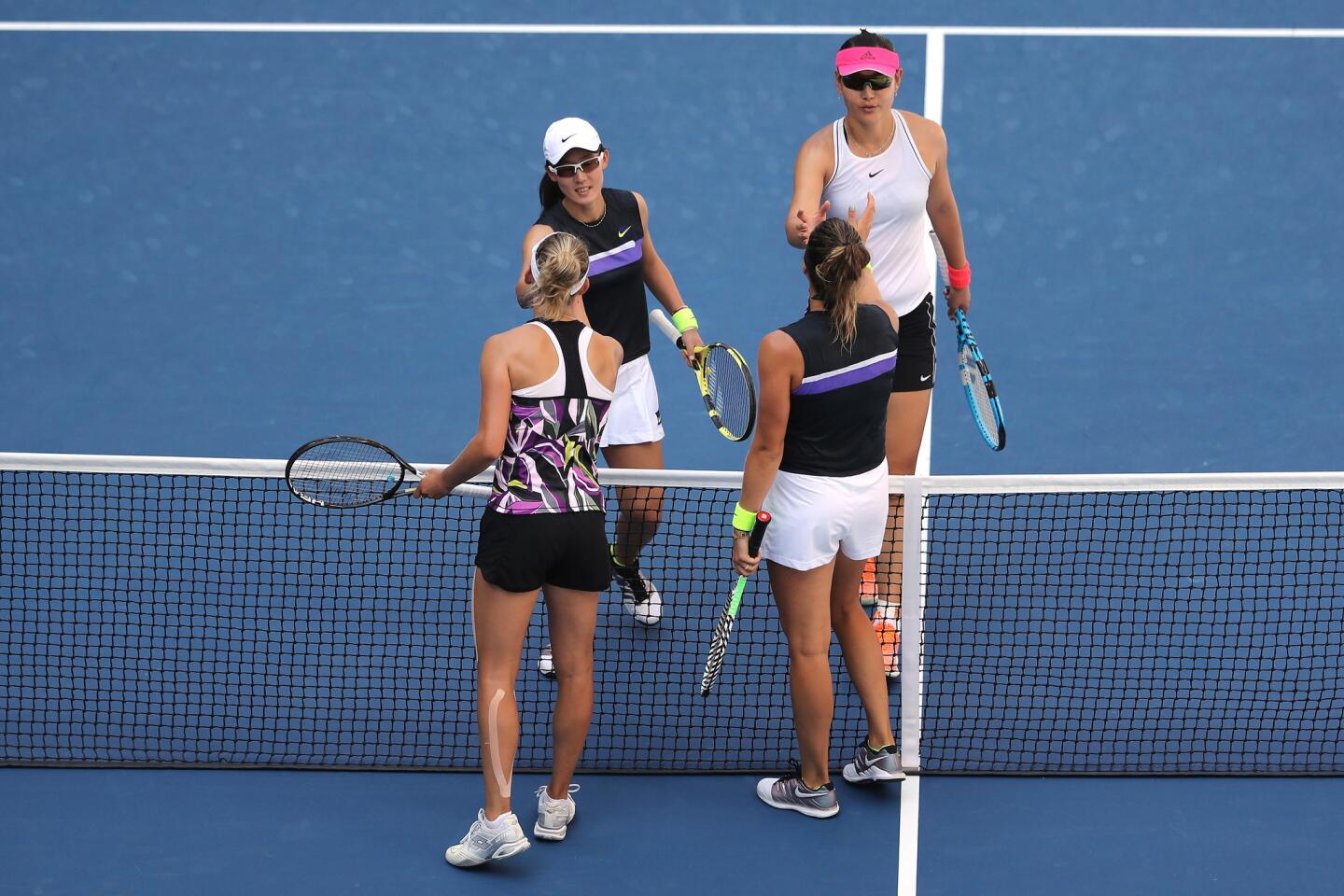 Elise Mertens of Belgium (R) and Aryna Sabalenka of Belarus shake hands after winning their Women's Doubles quarterfinal match against Saisai Zheng and Yingying Duan of China on day nine of the 2019 U.S. Open at the USTA Billie Jean King National Tennis Center on Sept. 3, 2019, in Queens.