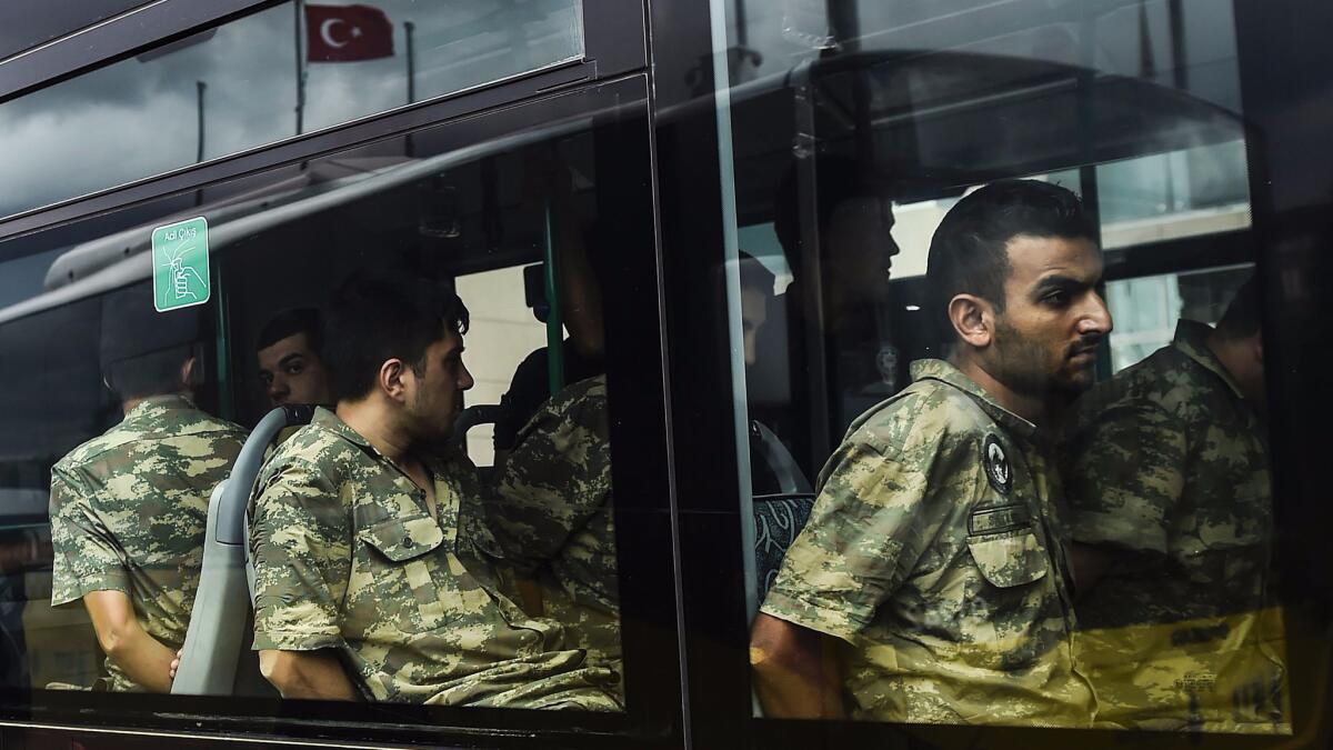 Detained Turkish soldiers accused of taking part in an attempted military coup arrive in a bus at the courthouse in Istanbul on Wednesday.