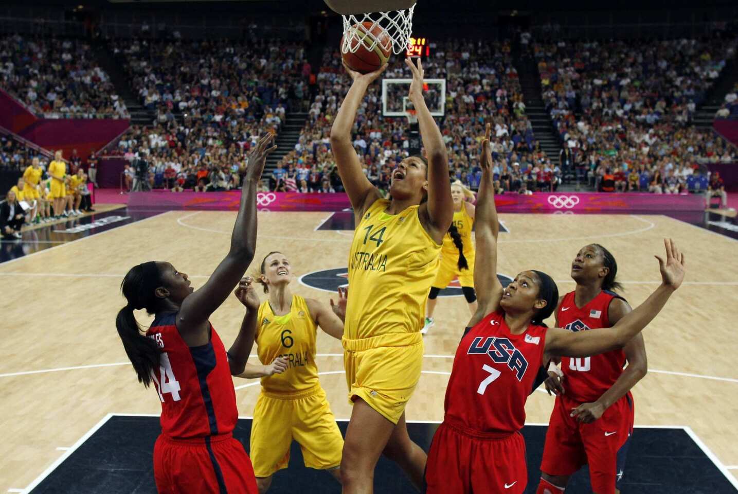 Australia's Liz Cambage shoots over Maya Moore, right, and Tina Charles of the United States in their semifinal match.