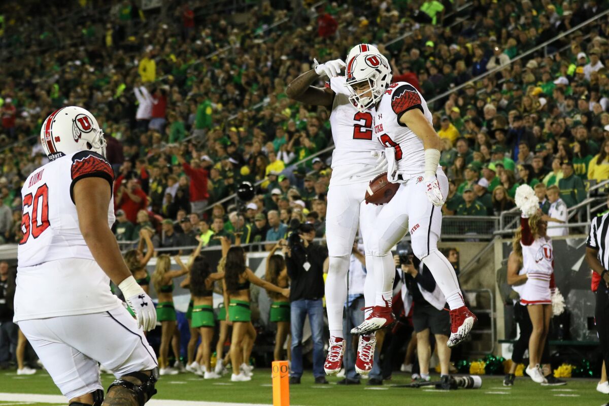 Utah wide receiver Britain Covey (18) celebrates with his teammates after scoring a touchdown during the second half against Oregon.
