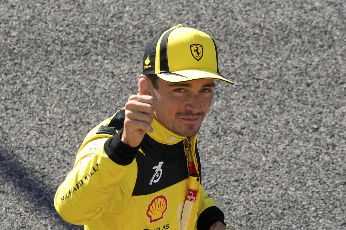 Ferrari driver Charles Leclerc of Monaco thumbs up after setting the pole position during the qualifying session at the Monza racetrack, in Monza, Italy, Saturday, Sept. 10, 2022. The Formula one race will be held on Sunday. (AP Photo/Luca Bruno)