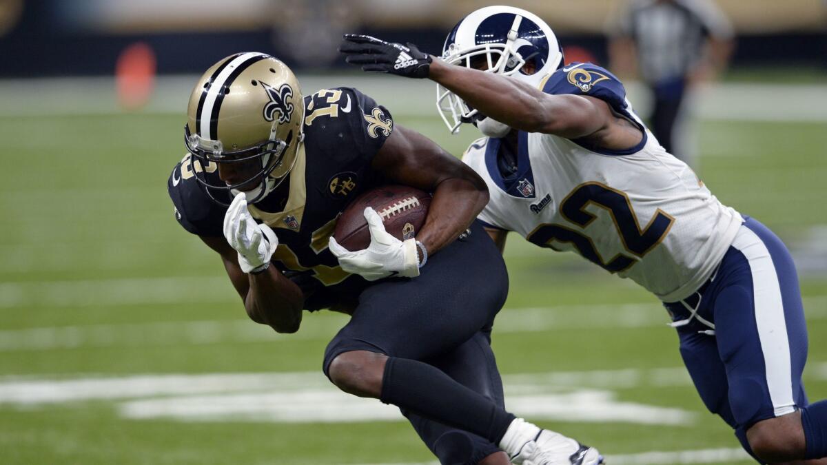Rams cornerback Marcus Peters (22) tries to tackle New Orleans Saints wide receiver Michael Thomas (13).