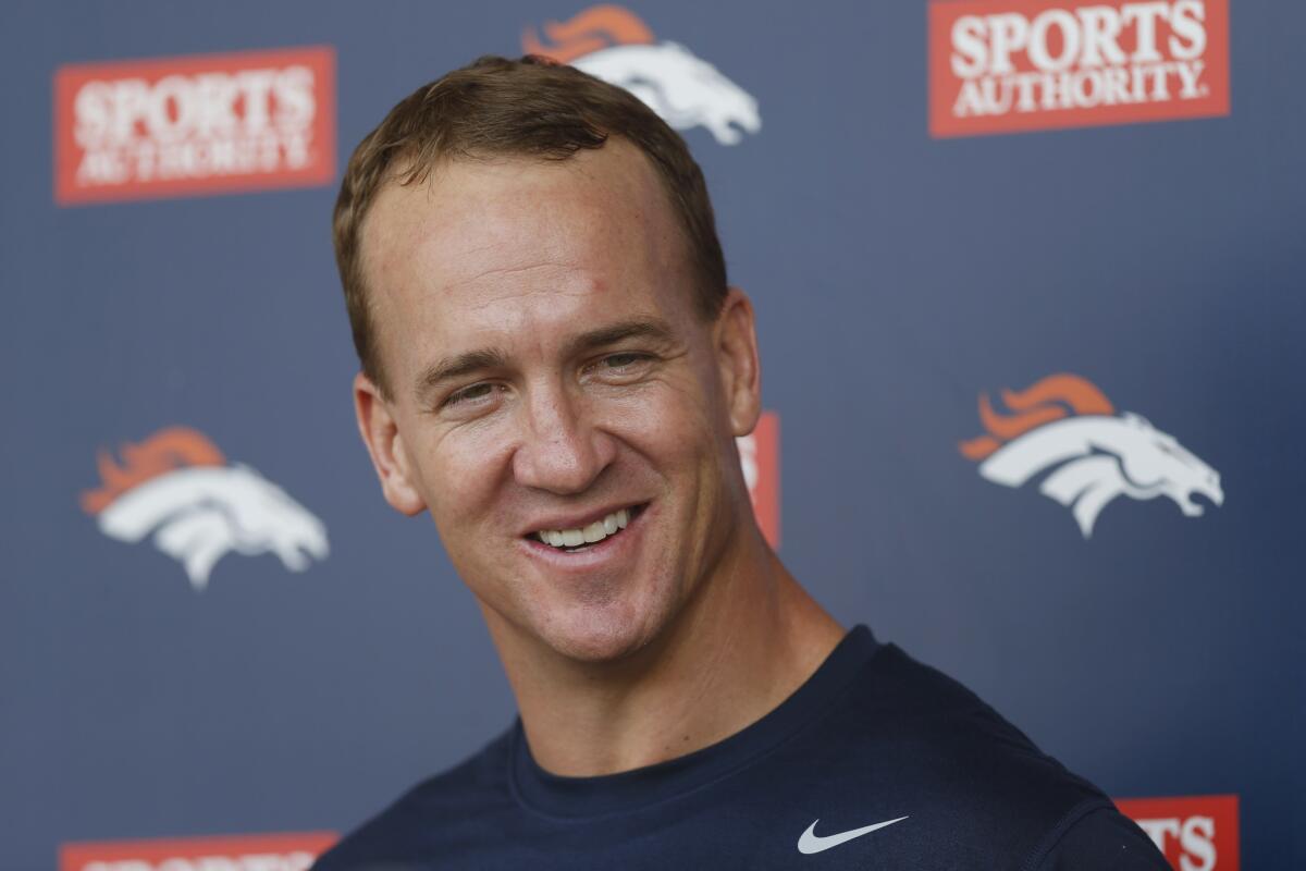 Denver Broncos quarterback Peyton Manning talks to reporters following NFL football minicamp at the team's headquarters June 10 in Englewood, Colo.