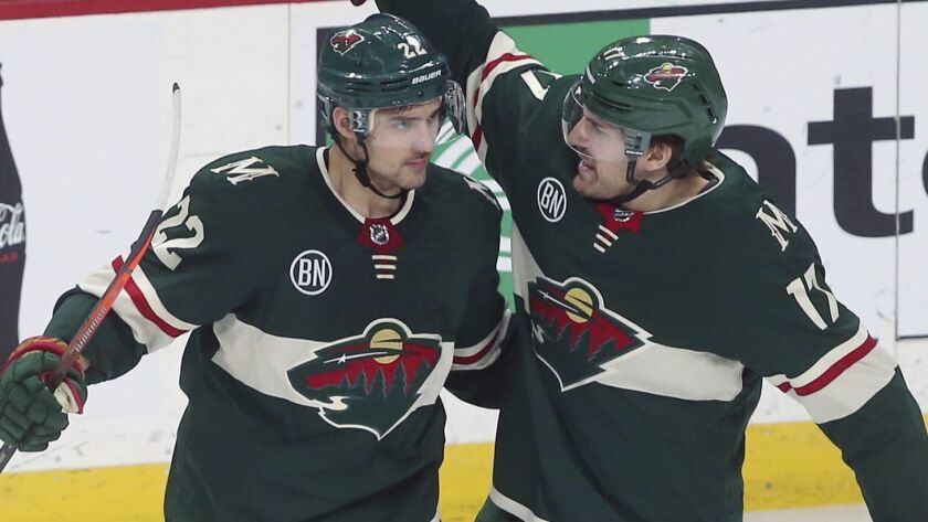 Minnesota Wild's Nino Niederreiter, left, is congratulated by Marcus Foligno after Niederreiter scored a goal off Kings goalie Jonathan Quick in the second period Tuesday.