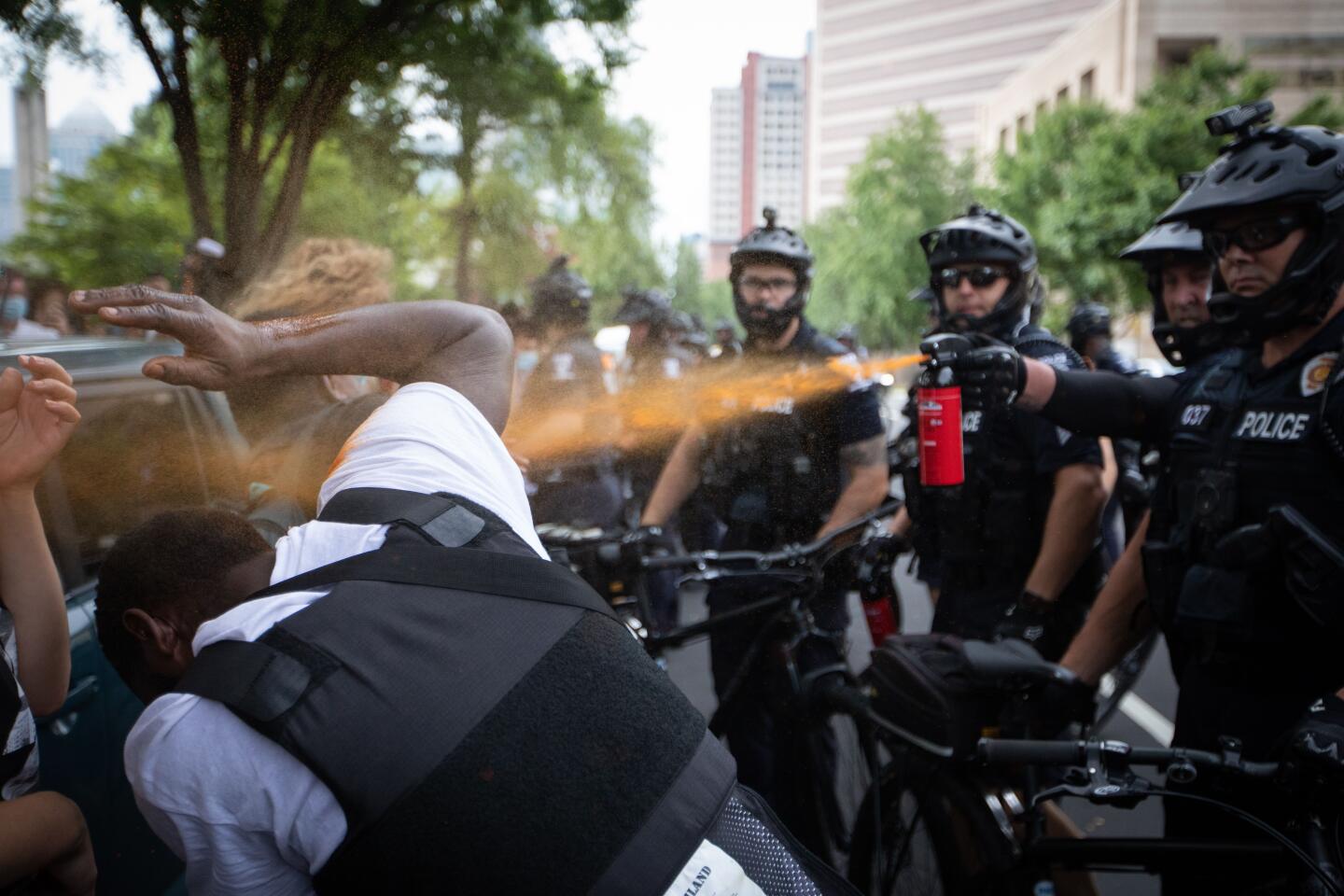 A police officer in Charlotte, N.C., pepper-sprays a protester outside the Republican National Convention.