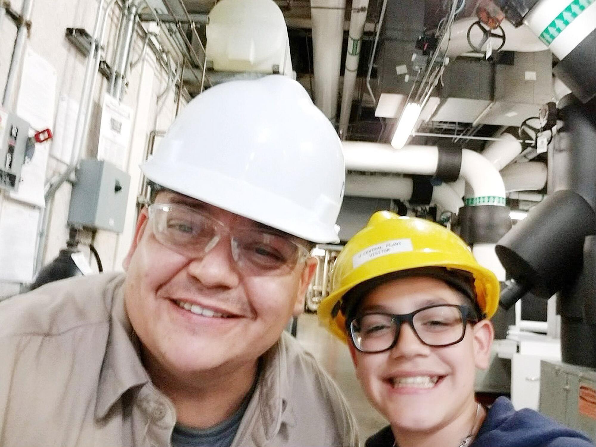 Anthony Reyes Jr. right, with his father, Anthony Reyes Sr., at the power plant where the elder Reyes worked.