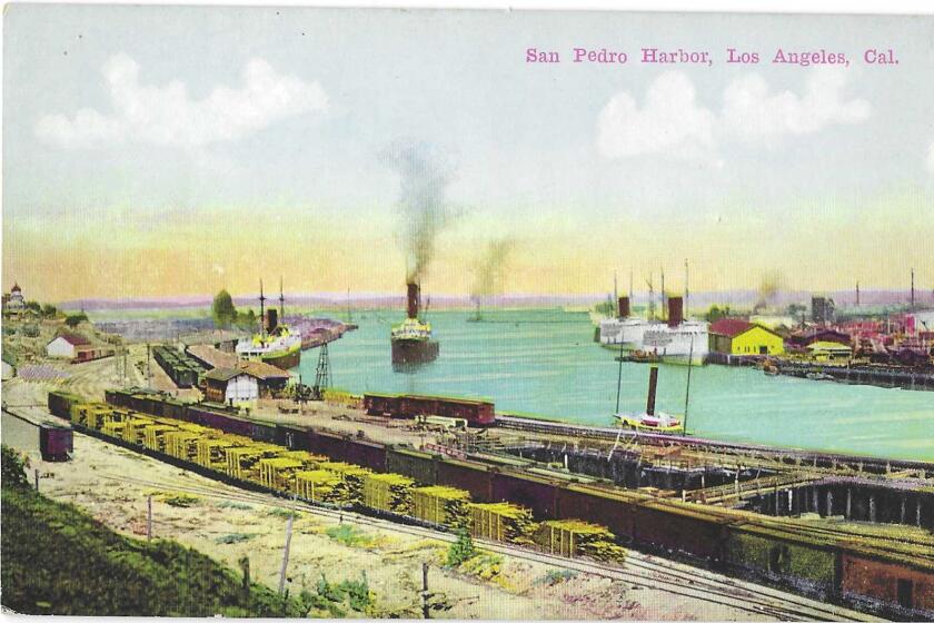 Ships with smokestacks belch smoke into the air in a scene at San Pedro Harbor