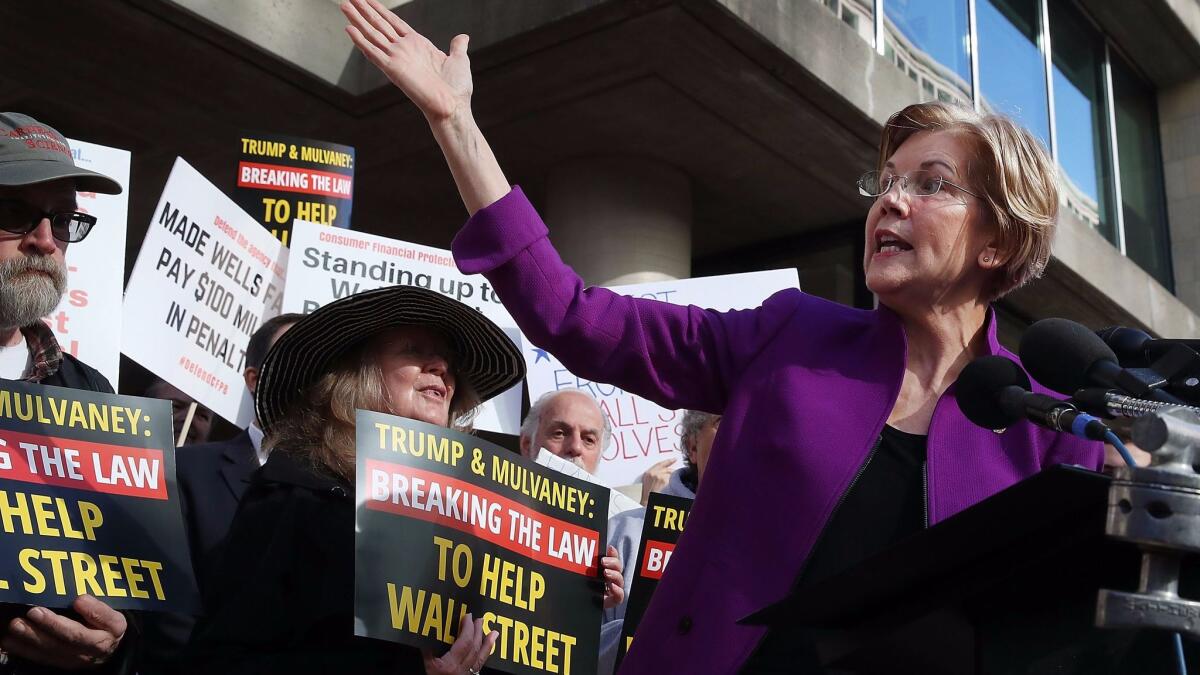 Sen. Elizabeth Warren (D-Mass.) speaks during a protest in front of the Consumer Financial Protection Bureau headquarters on Tuesday.