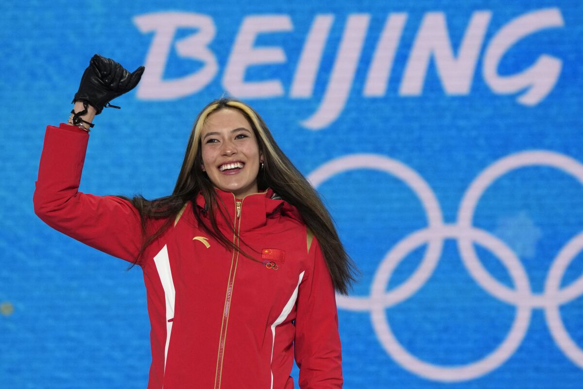 FILE - Gold medalist China's Eileen Gu celebrates during a medal ceremony for the women's freestyle skiing halfpipe competition at the 2022 Winter Olympics, Friday, Feb. 18, 2022, in Zhangjiakou, China. Gu, the California-born athlete who won two gold medals for China in freestyle skiing at the recent Beijing Olympics, has signed on to work for Salt Lake City's bid for the 2030 or 2034 Winter Olympics.(AP Photo/Alessandra Tarantino, File)