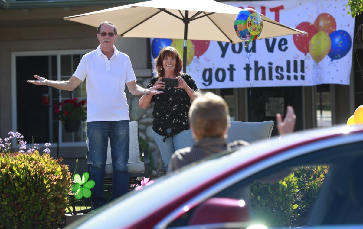 Walt Ekard reacts to seeing former San Diego District Attorney Bonnie Dumanis during a drive-by “get well soon” event at his Alpine home on May 24.
