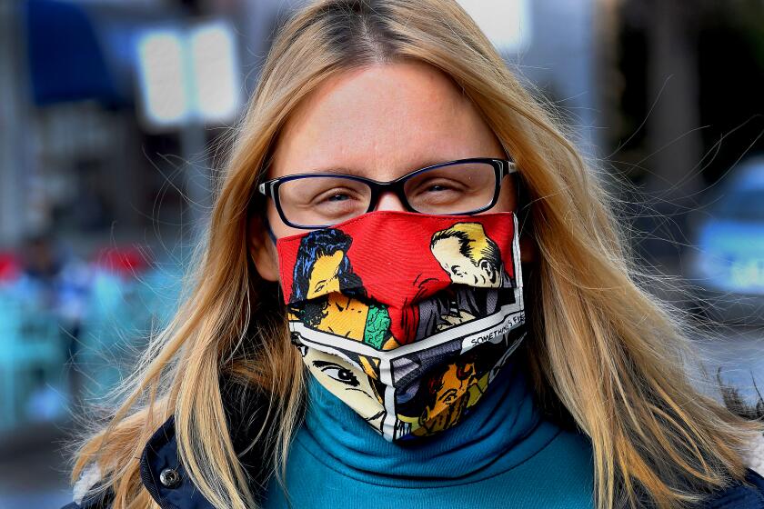 CROATIA: A picture taken in Zagreb shows a woman wearing a protective face mask designed by Croatian designer Zoran Aragovic. - Triggered by coronavirus epidemic he designed mask of cotton in his distictivepop art style.