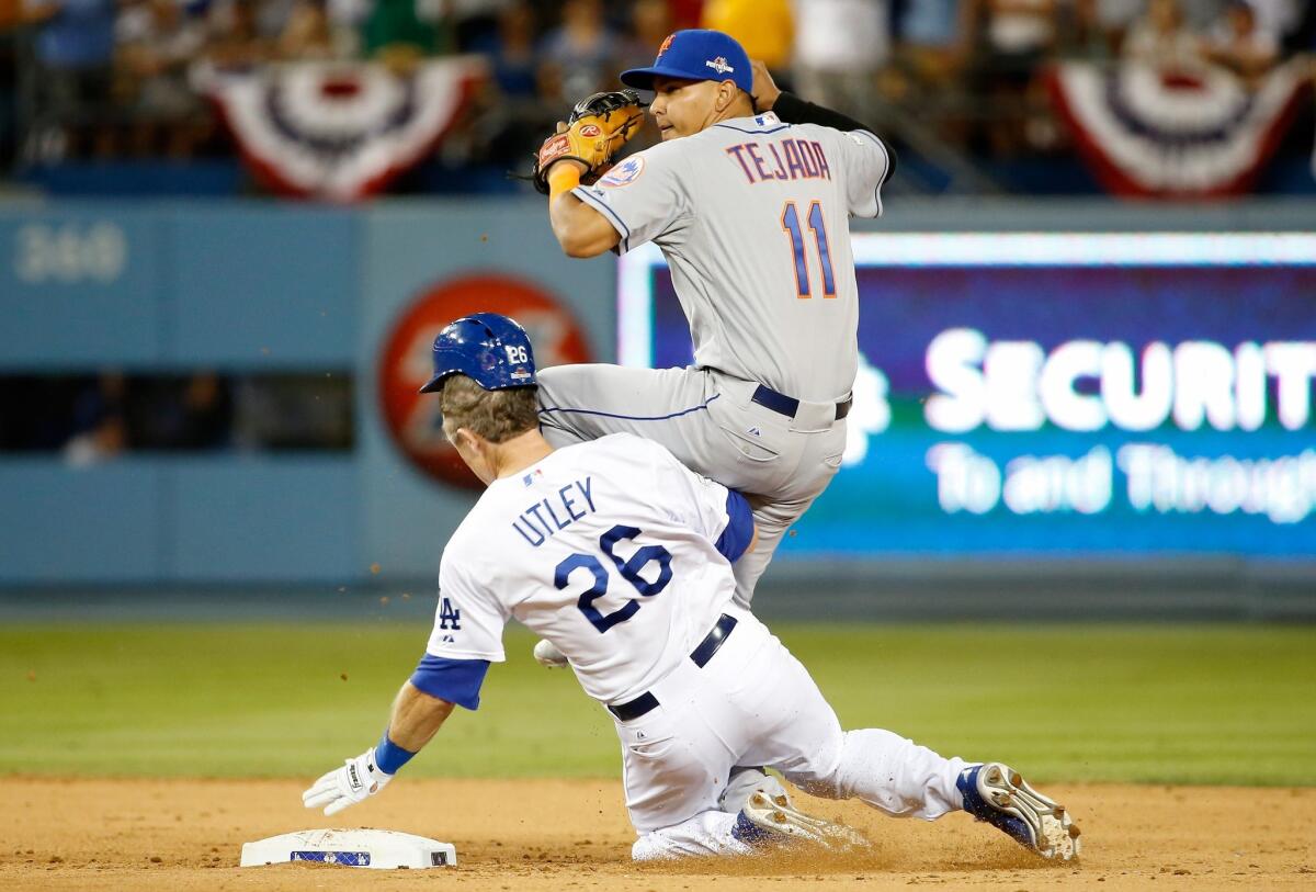 Dodgers' Chase Utley slides into New York Mets' Ruben Tejada on Saturday night.
