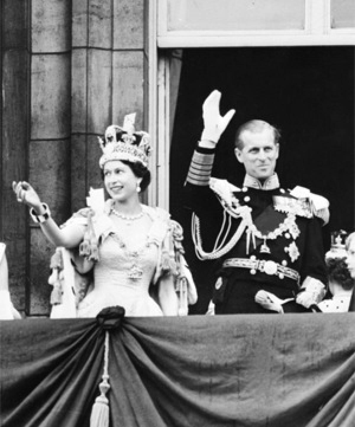 In a file picture taken on June 2, 1953 Britain's Queen Elizabeth II accompanied by Prince Philip waves to the crowd after being crowned during her coronation at Westminter Abbey in London.