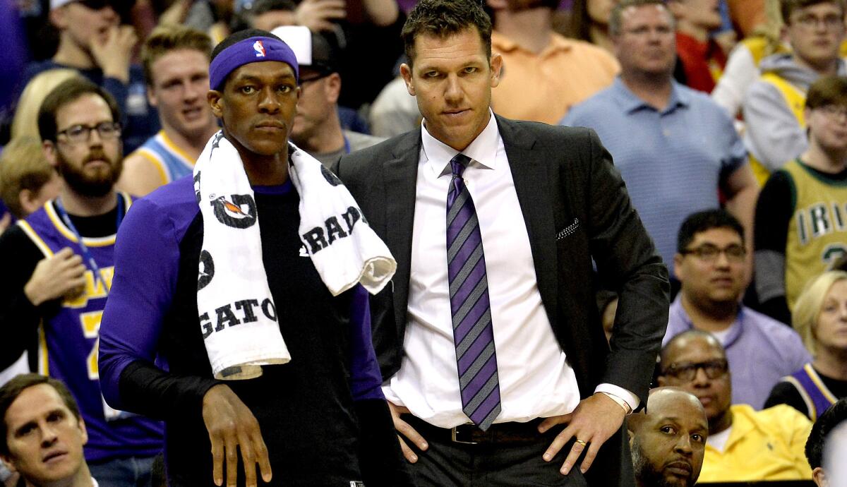 Lakers guard Rajon Rondo and coach Luke Walton watch play from the sideline during a 110-105 loss to the Grizzlies on Monday in Memphis, Tenn.